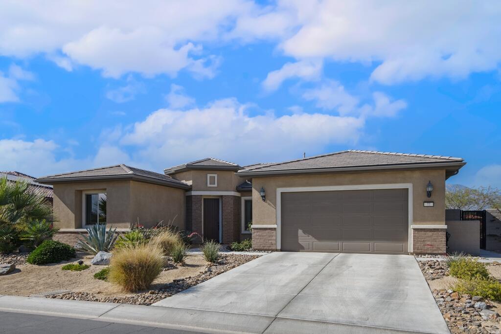 77 Barolo Rancho Mirage, CA 92270 - Photo 11 of 61 a front view of a house with a yard and garage