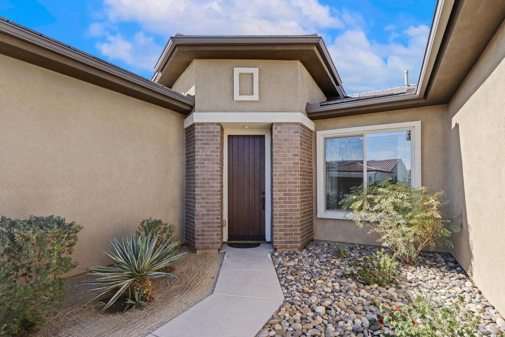 77 Barolo Rancho Mirage, CA 92270 - Photo 18 of 61 a front view of a house with garden