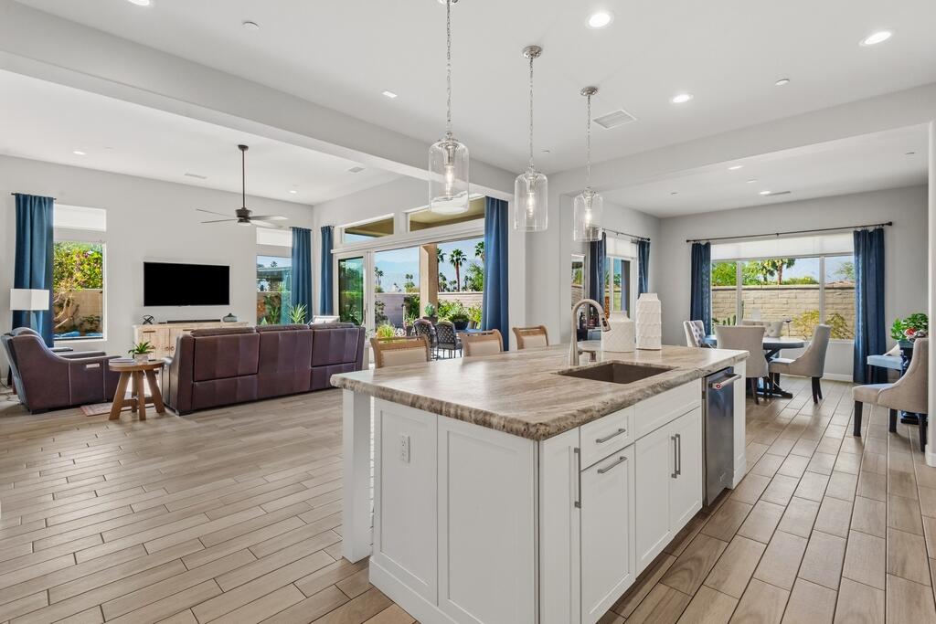 77 Barolo Rancho Mirage, CA 92270 - Photo 26 of 61 a kitchen with stainless steel appliances granite countertop a stove and a wooden floors