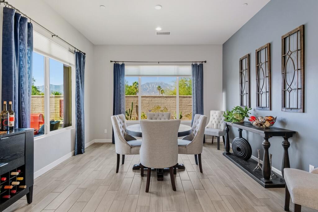 77 Barolo Rancho Mirage, CA 92270 - Photo 3 of 61 a view of a dining room with furniture window and wooden floor
