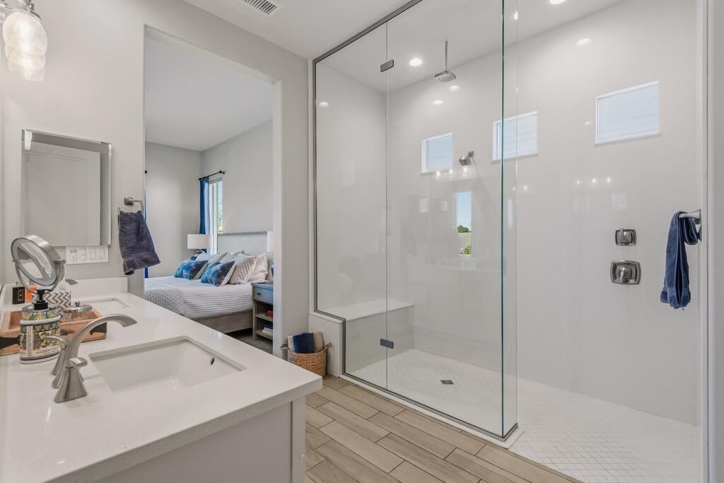 77 Barolo Rancho Mirage, CA 92270 - Photo 36 of 61 a bathroom with a shower sink vanity and mirror