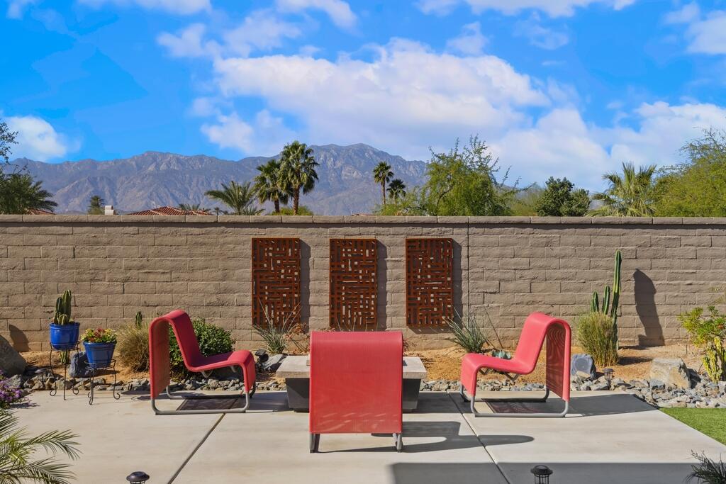 77 Barolo Rancho Mirage, CA 92270 - Photo 49 of 61 a view of a patio with table and chairs with wooden floor and fence