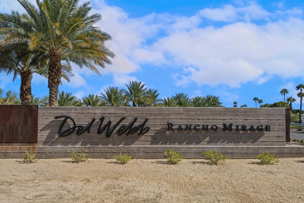 77 Barolo Rancho Mirage, CA 92270 - Photo 57 of 61 a view of a swimming pool with a lawn chairs under an umbrella