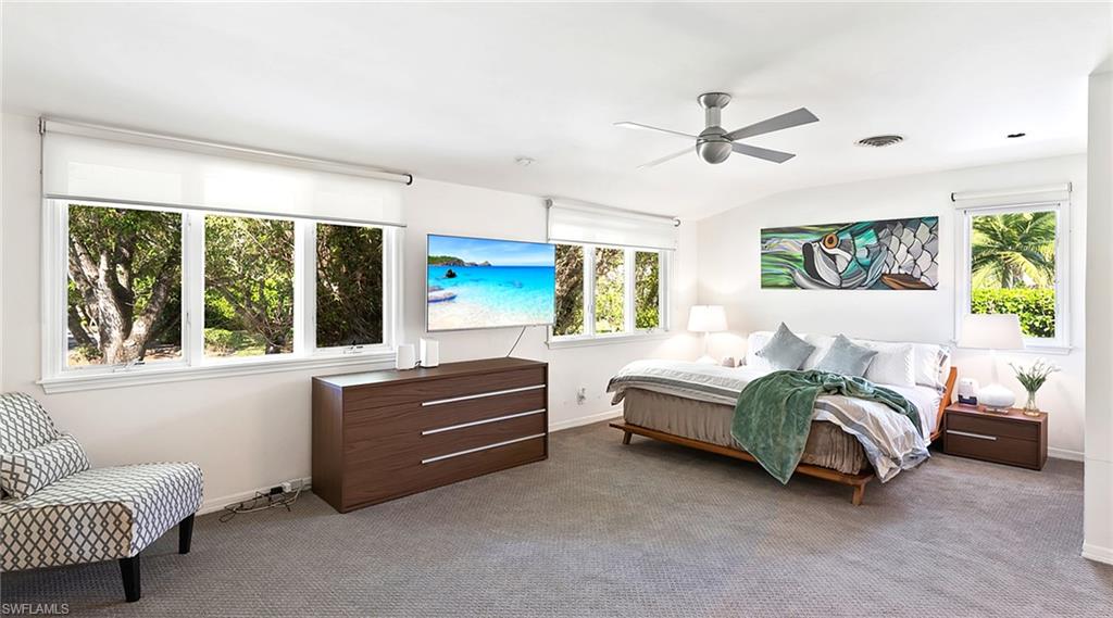586 Yucca Road Naples, FL 34102 - Photo 19 of 26 Carpeted bedroom with multiple windows and ceiling fan