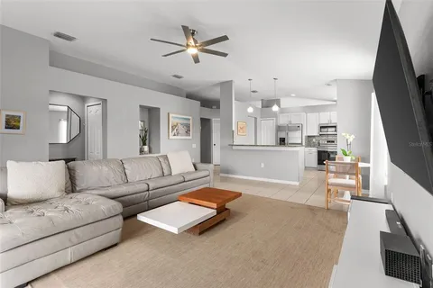 a kitchen with stainless steel appliances kitchen island granite countertop a stove a sink and a refrigerator