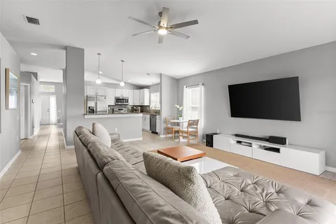 a kitchen with granite countertop a refrigerator and a sink