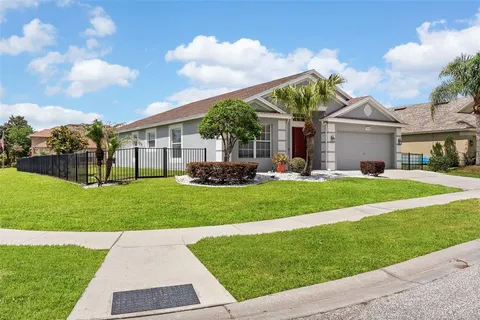 a front view of house with yard and green space