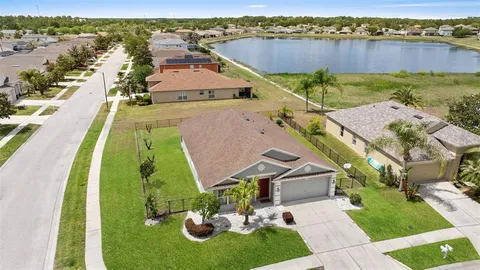 an aerial view of a house with a garden and lake view