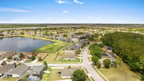 an aerial view of residential building and lake