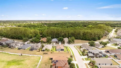 a view of a house with pool and a yard