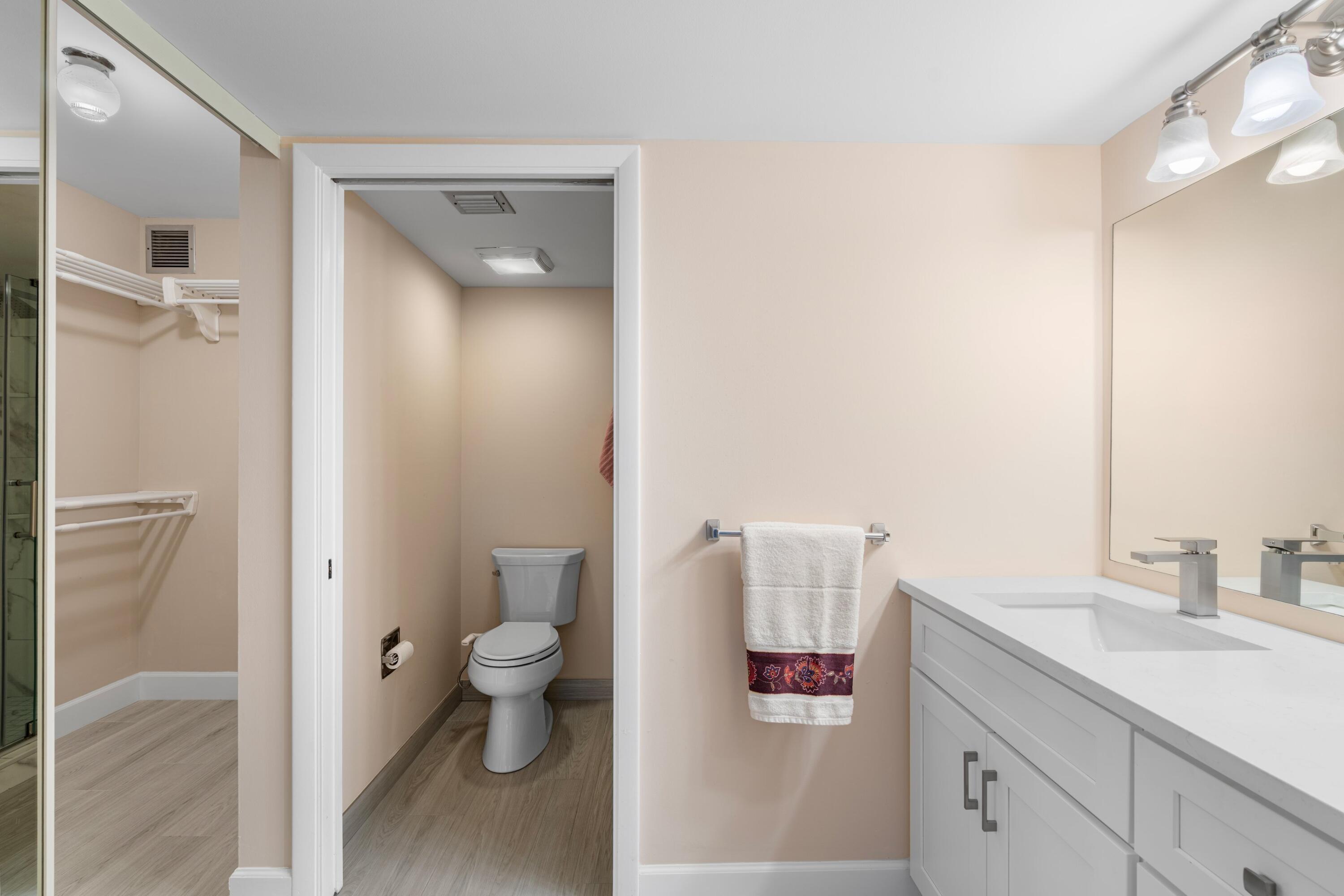 6025 Balboa Circle, Unit 406 Boca Raton, FL 33433 - Photo 13 of 33 a bathroom with a sink a toilet and shower