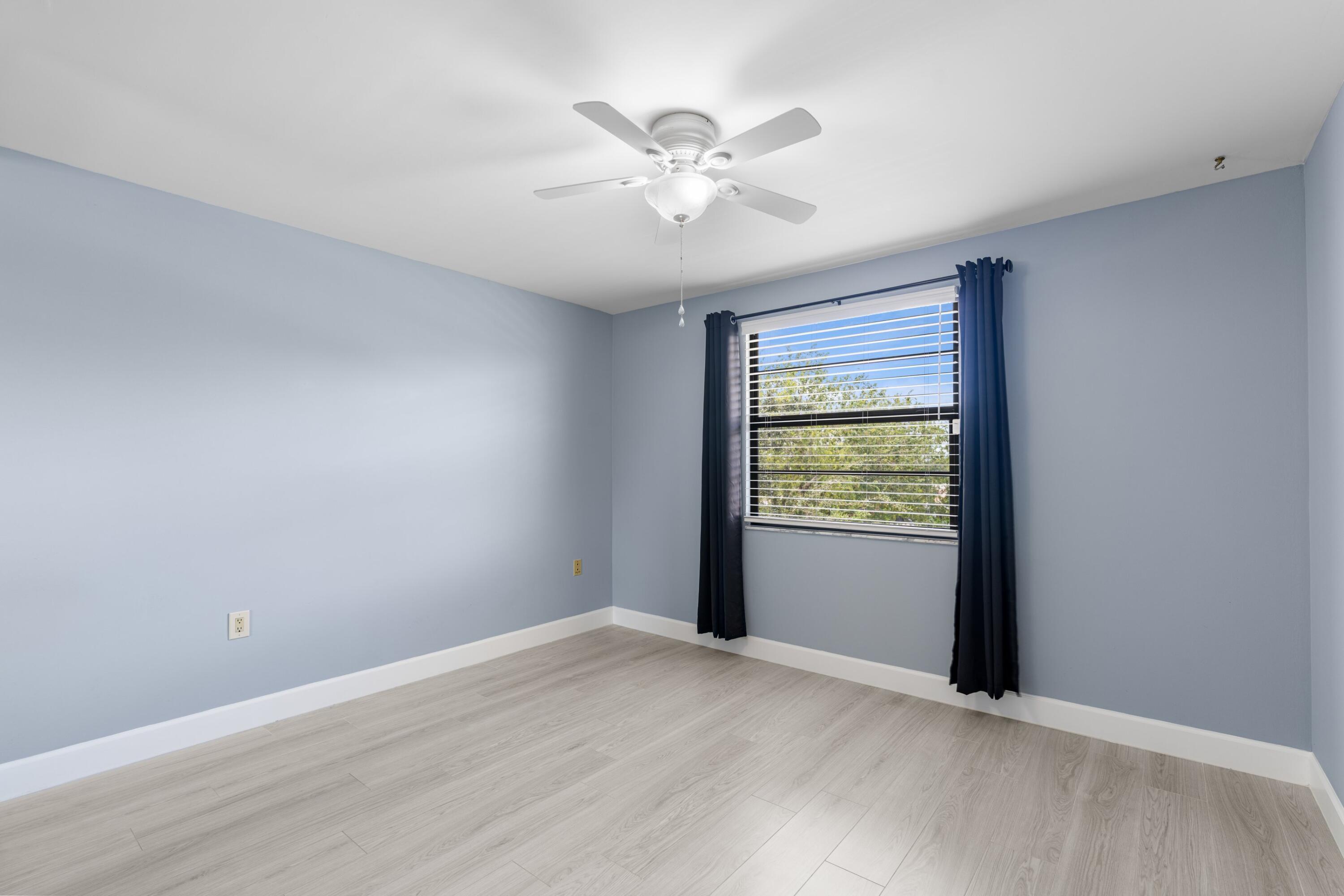 6025 Balboa Circle, Unit 406 Boca Raton, FL 33433 - Photo 16 of 33 wooden floor in an empty room with a window