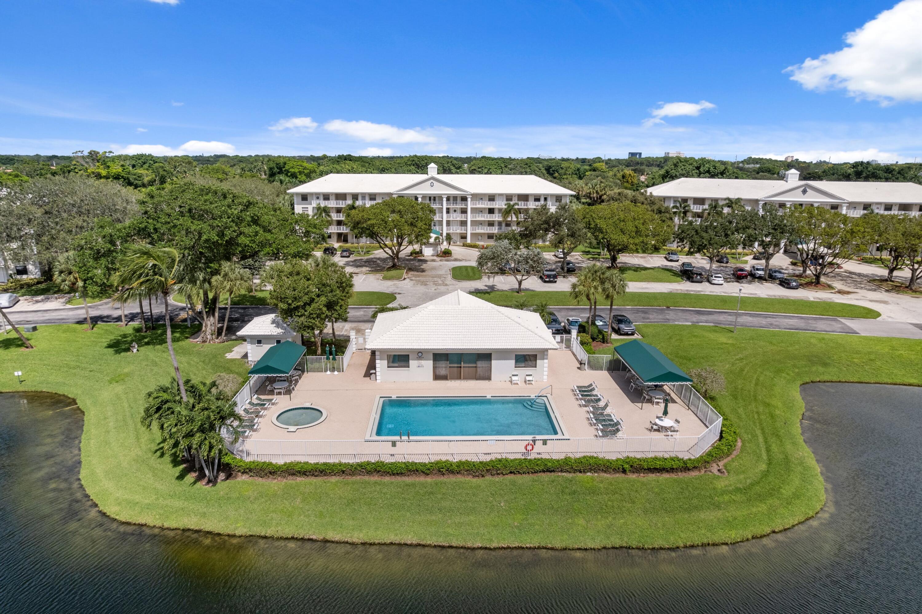 6025 Balboa Circle, Unit 406 Boca Raton, FL 33433 - Photo 25 of 33 a view of a swimming pool with a yard
