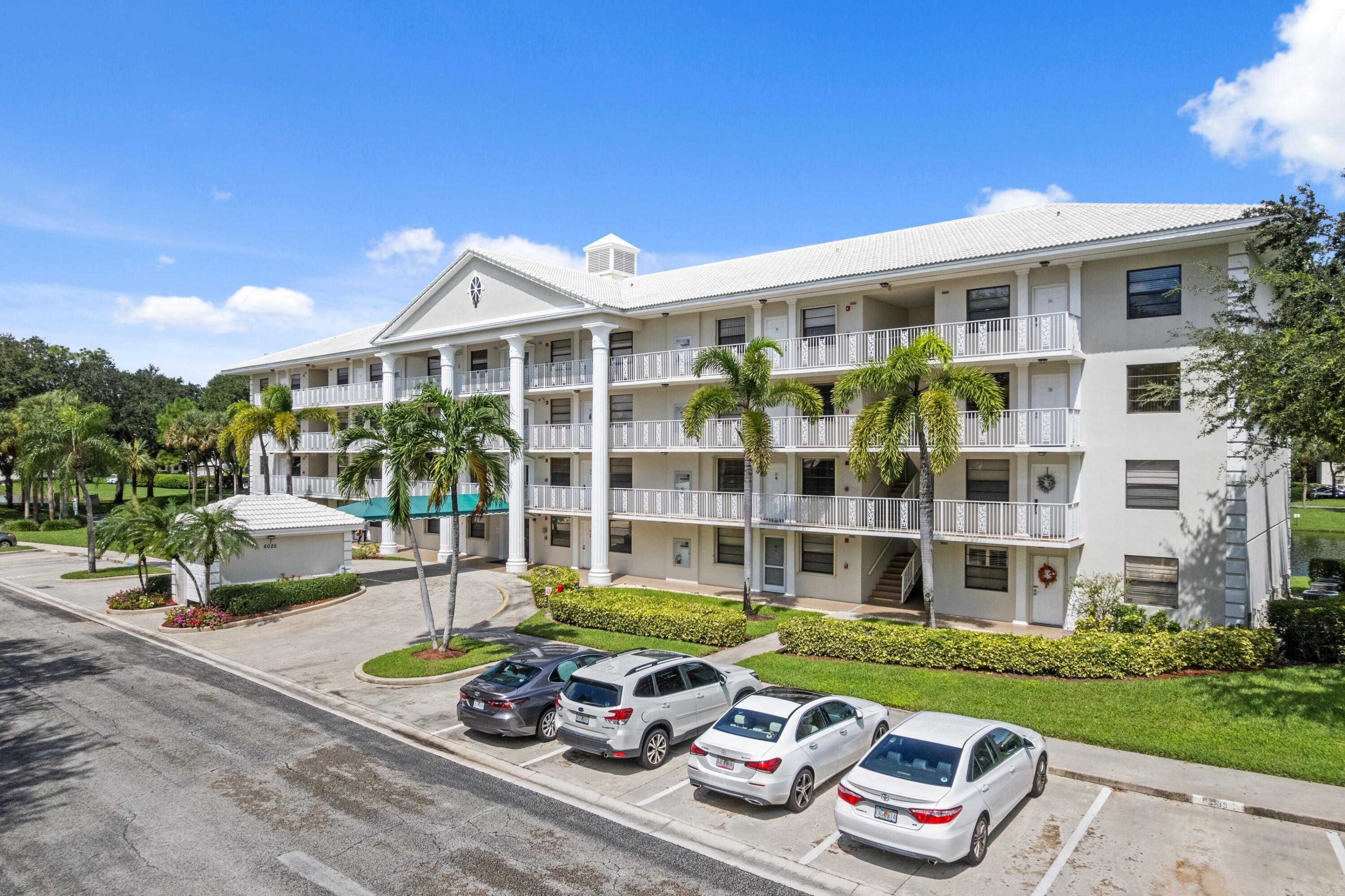 6025 Balboa Circle, Unit 406 Boca Raton, FL 33433 - Photo 26 of 33 a front view of a house with a garden and patio