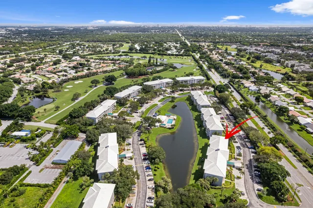 an aerial view of residential houses with outdoor space and trees