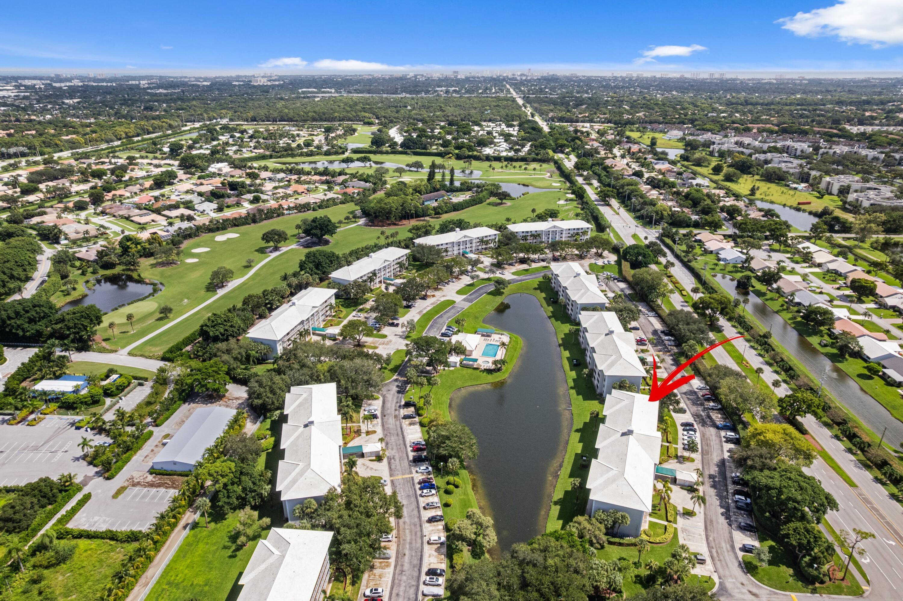 6025 Balboa Circle, Unit 406 Boca Raton, FL 33433 - Photo 29 of 33 an aerial view of residential houses with outdoor space and trees