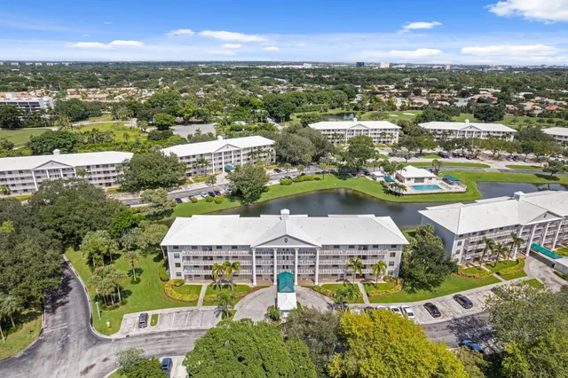 an aerial view of residential houses with outdoor space and river
