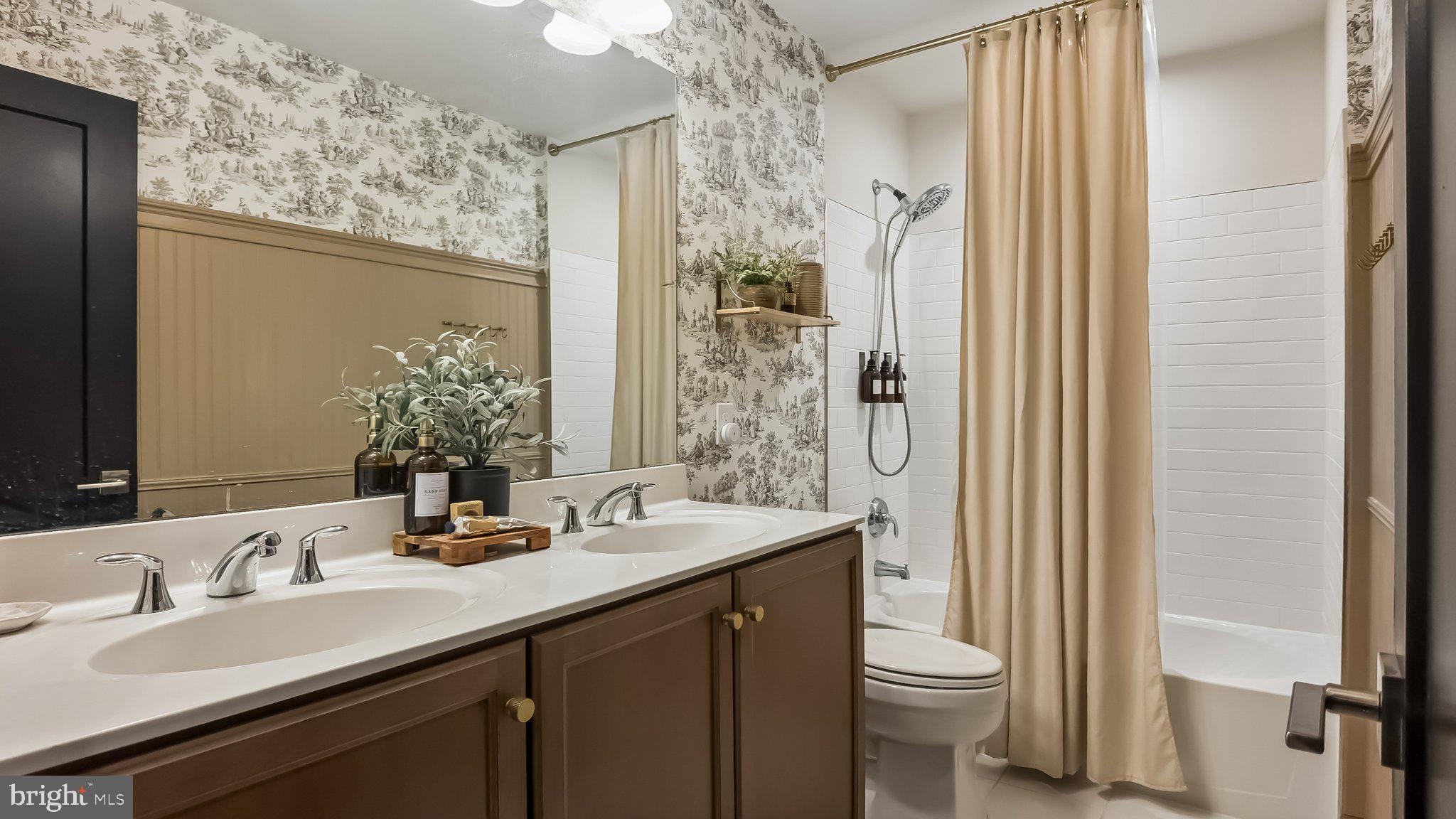 257 Junction Road Media, PA 19063 - Photo 18 of 25 a bathroom with a double vanity sink toilet and a mirror