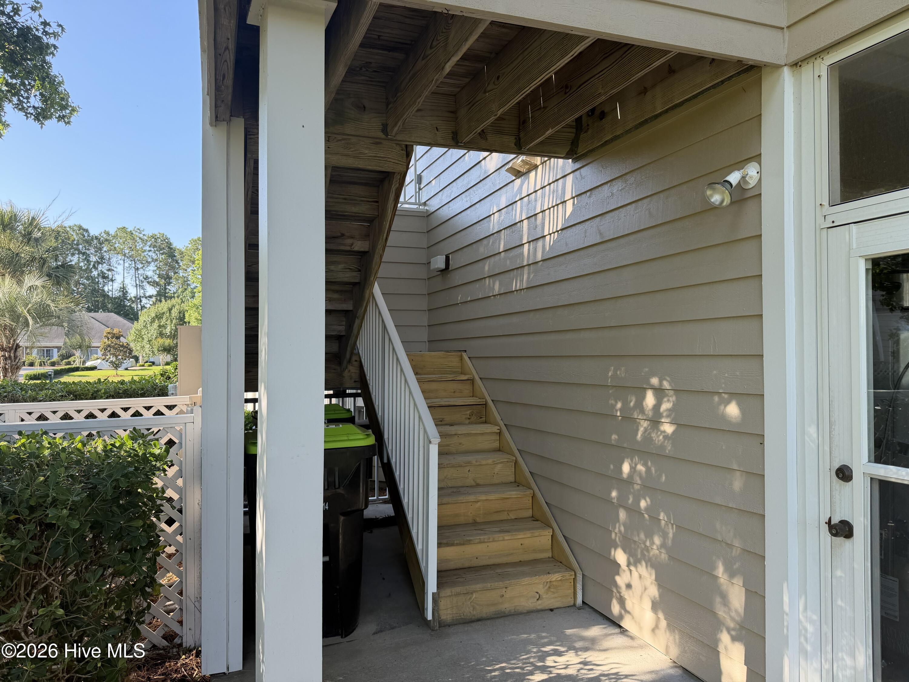 116 Rice Mill Circle, Unit 4 Sunset Beach, NC 28468 - Photo 4 of 29 Back outdoor staircase from ground level up to unit.