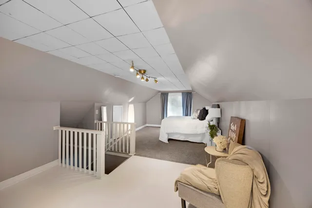 a bedroom with furniture and a chandelier