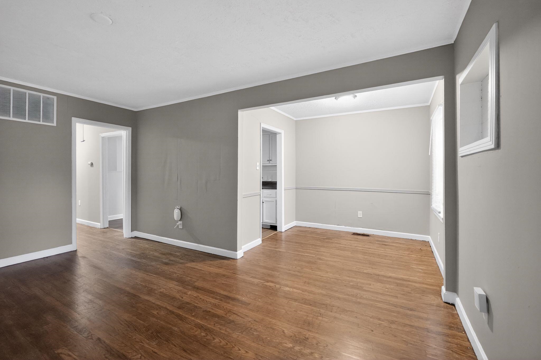 4067 Grantham Road Memphis, TN 38109 - Photo 18 of 34 a view of an empty room with wooden floor and a window