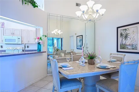 a view of a dining room with furniture and chandelier