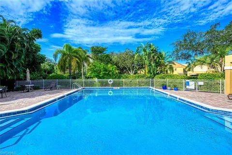 a view of a swimming pool with a yard