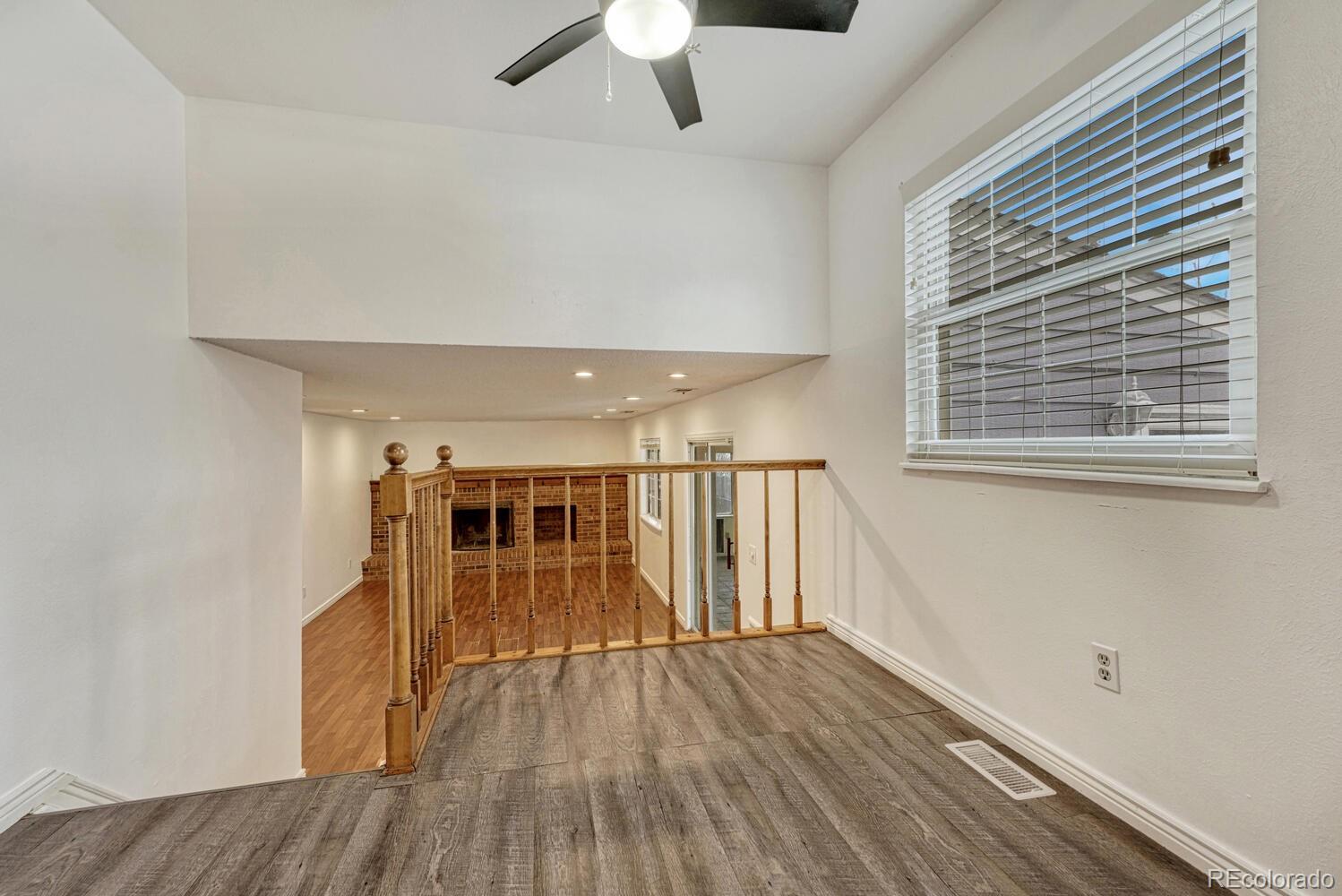 2079 South Quintero Street Aurora, CO 80013 - Photo 15 of 37 a view of empty room with wooden floor and fan