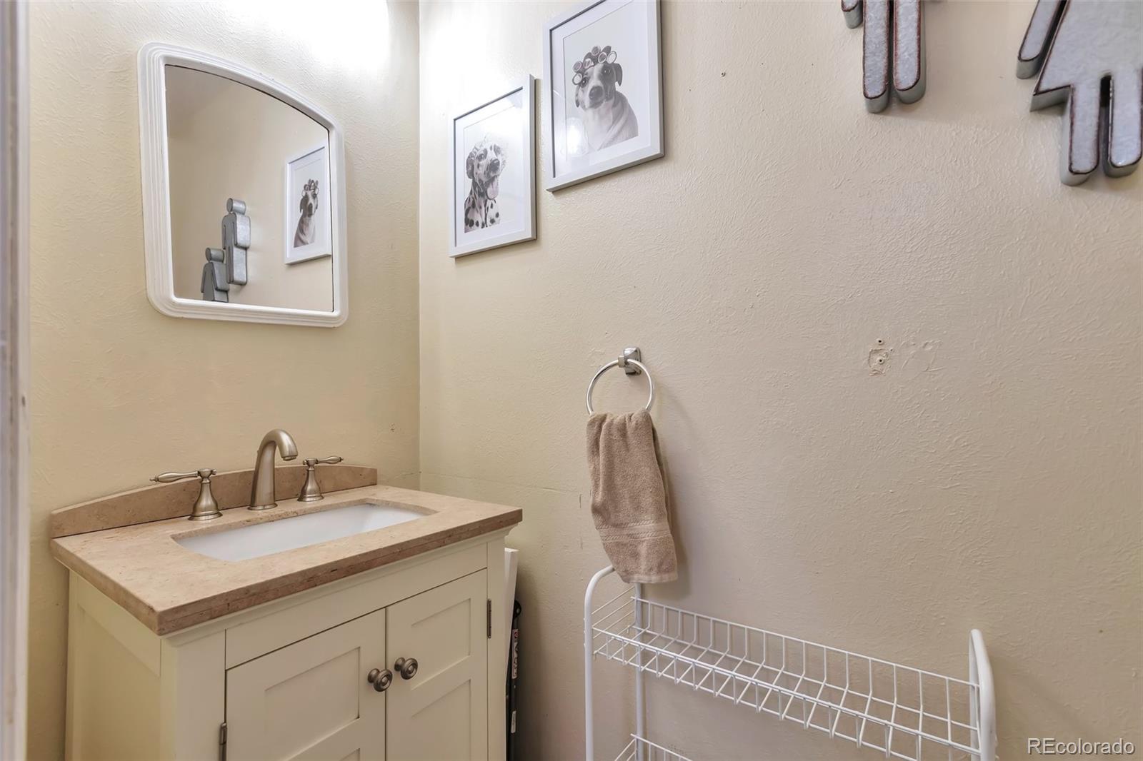 2079 South Quintero Street Aurora, CO 80013 - Photo 17 of 35 a bathroom with a sink and a mirror