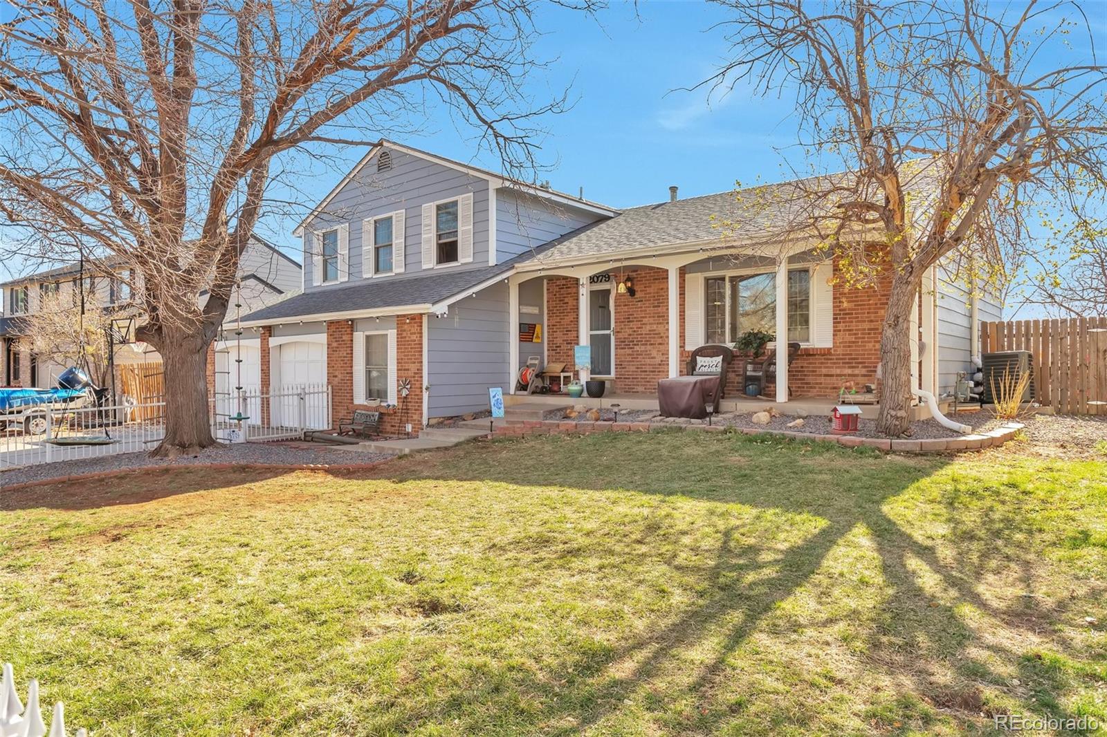 2079 South Quintero Street Aurora, CO 80013 - Photo 2 of 35 a front view of a house with swimming pool and porch with furniture