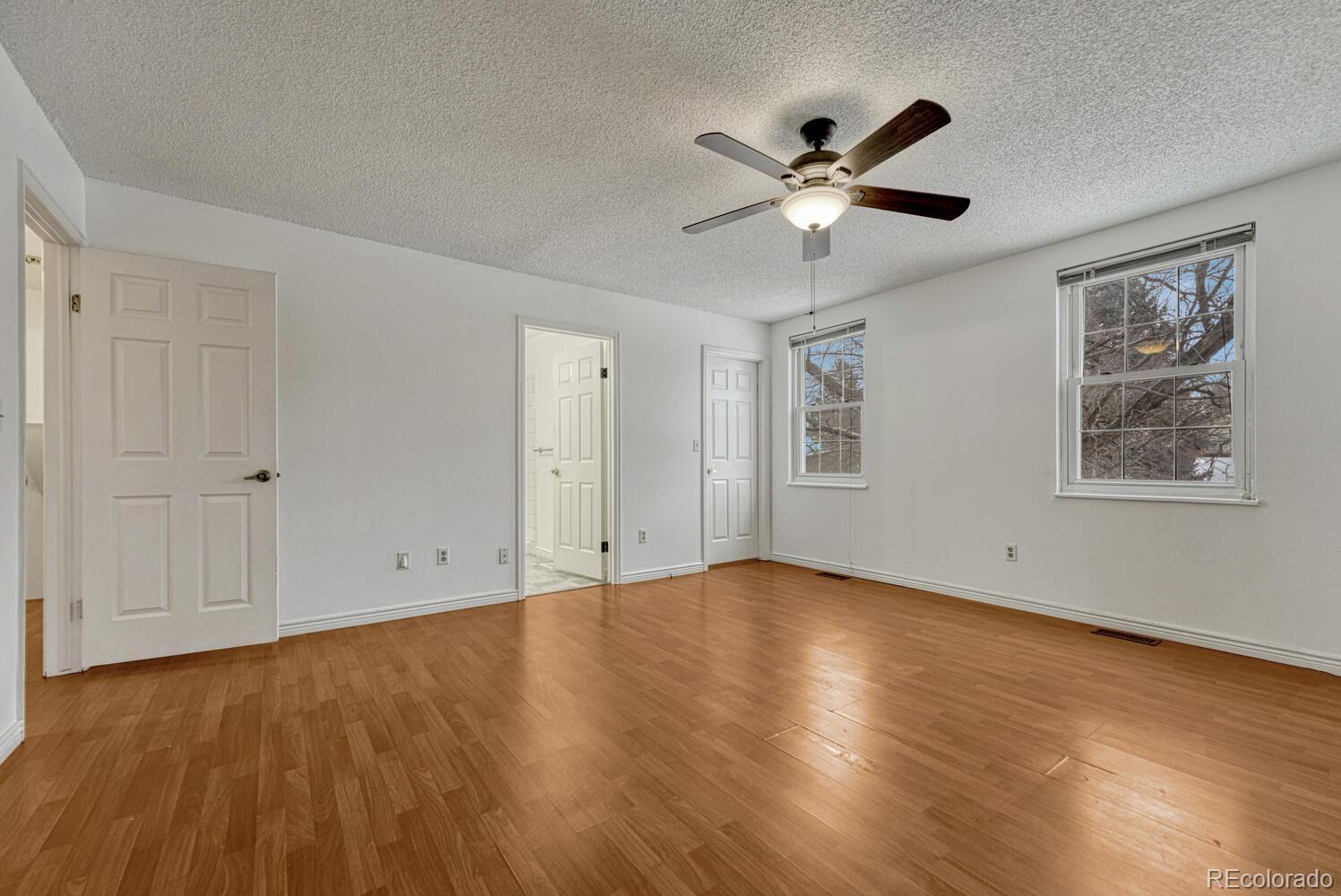 2079 South Quintero Street Aurora, CO 80013 - Photo 21 of 35 a view of an empty room with window and wooden floor