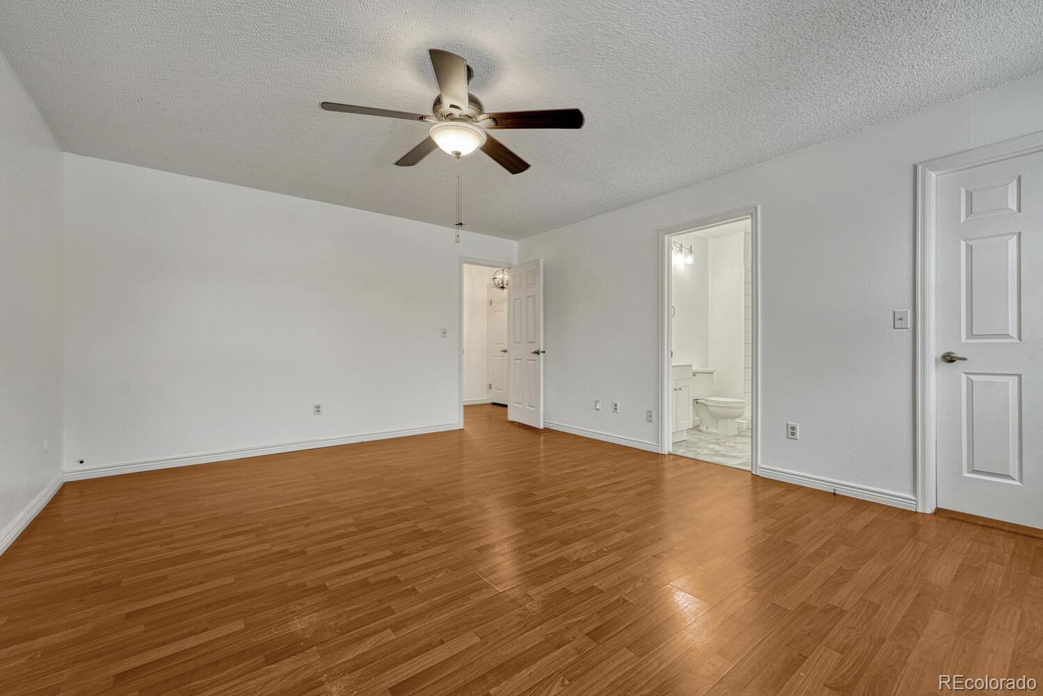 2079 South Quintero Street Aurora, CO 80013 - Photo 22 of 35 a view of an empty room with wooden floor