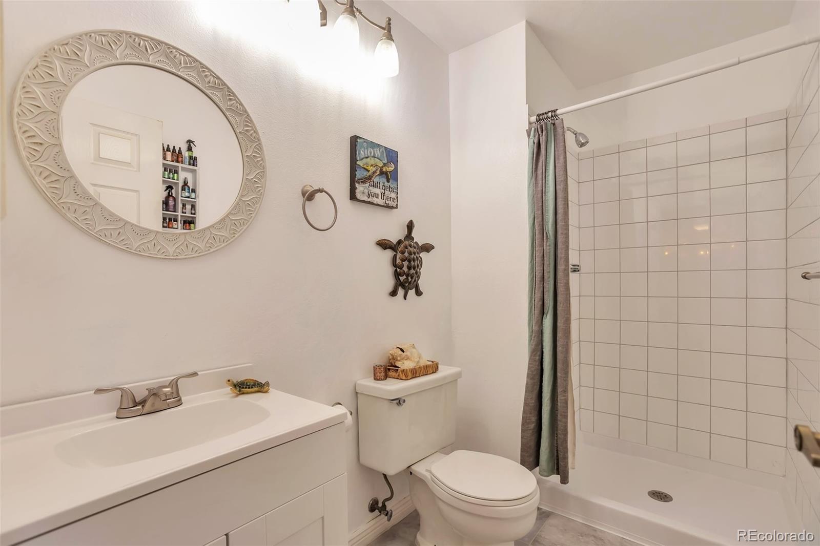 2079 South Quintero Street Aurora, CO 80013 - Photo 25 of 37 a bathroom with a toilet a sink and a mirror