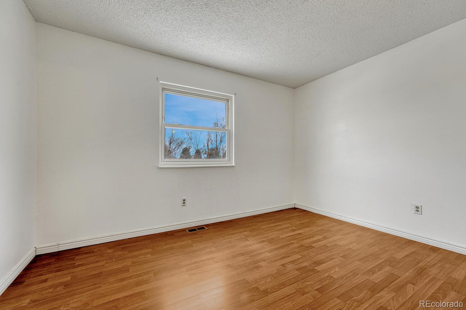 2079 South Quintero Street Aurora, CO 80013 - Photo 28 of 37 a view of empty room with wooden floor