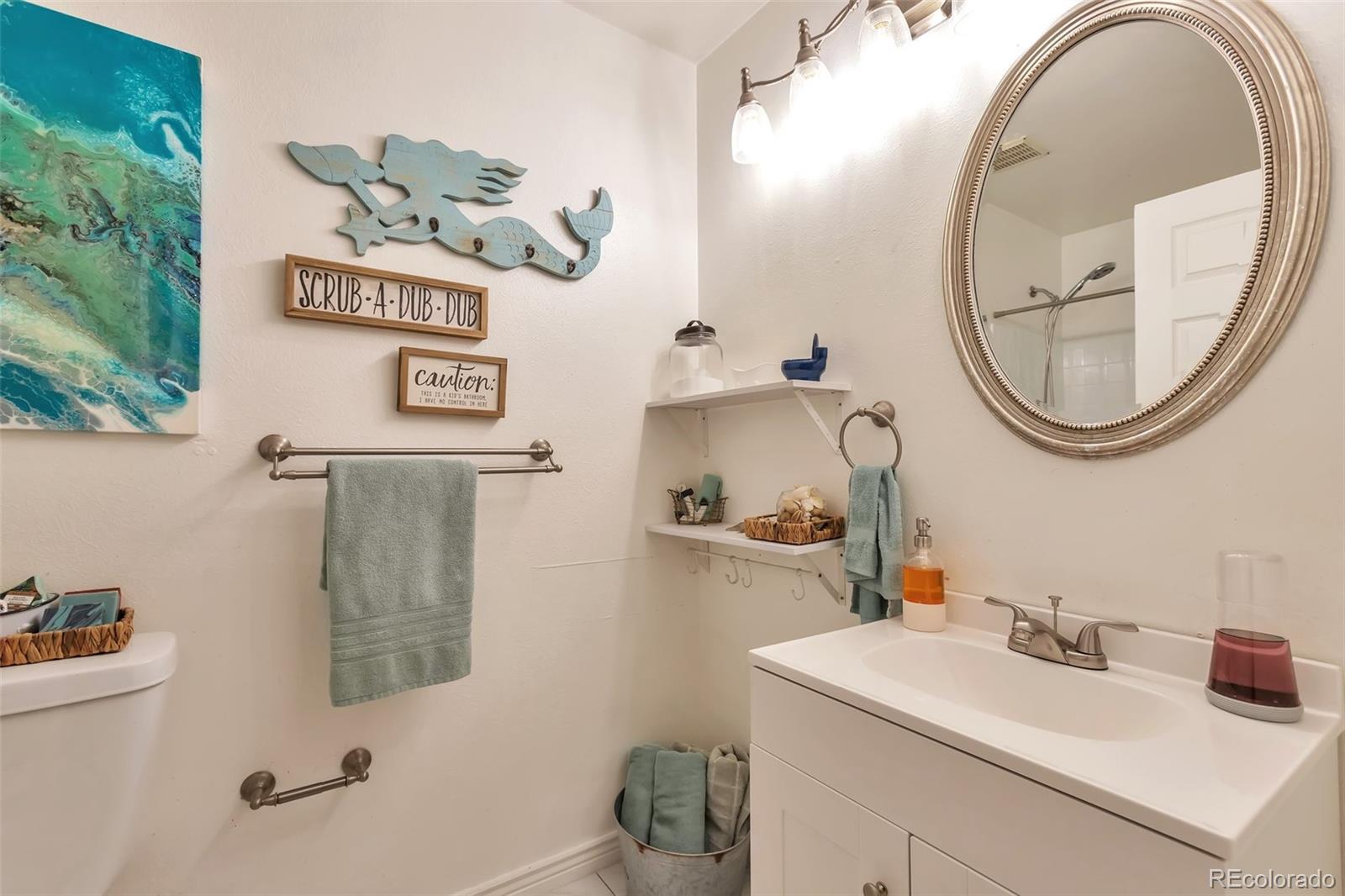 2079 South Quintero Street Aurora, CO 80013 - Photo 30 of 37 a bathroom with a sink and a mirror