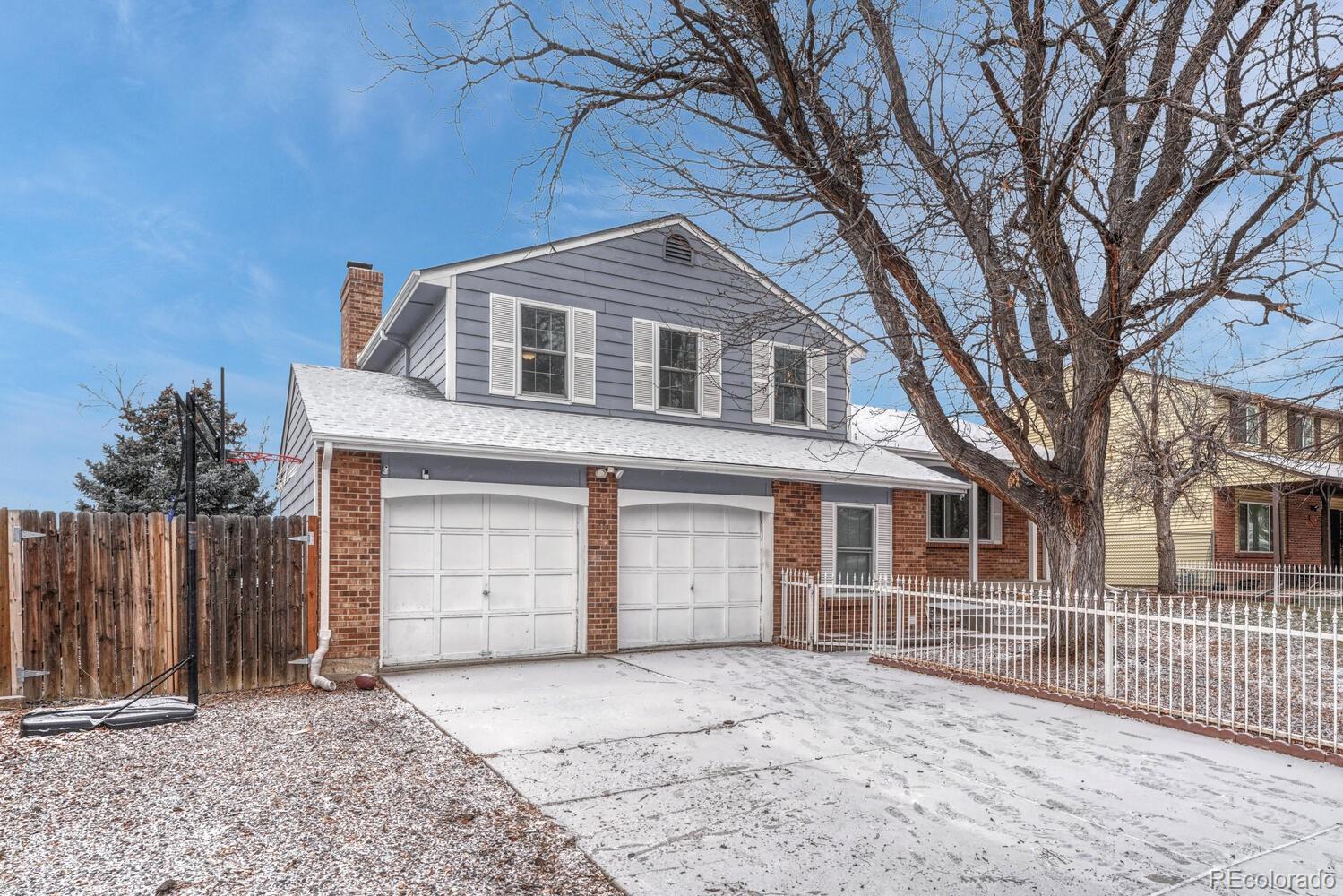 2079 South Quintero Street Aurora, CO 80013 - Photo 3 of 37 a front view of a house with a garage
