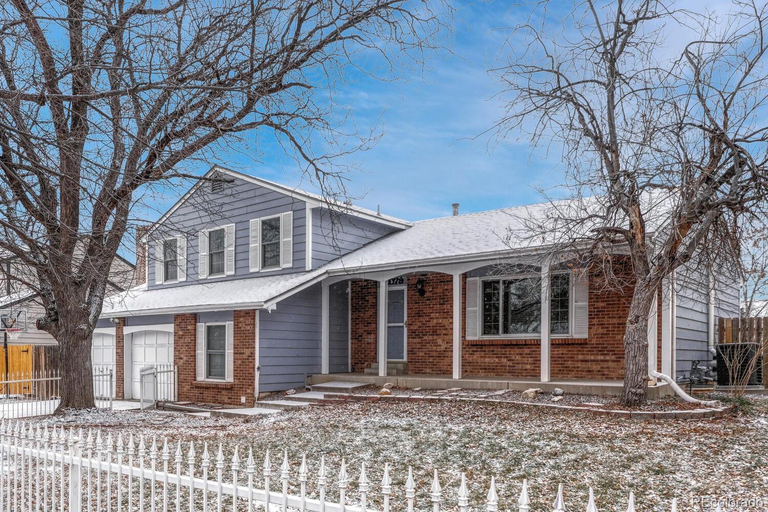 2079 South Quintero Street Aurora, CO 80013 - Photo 5 of 37 a front view of a house with a yard