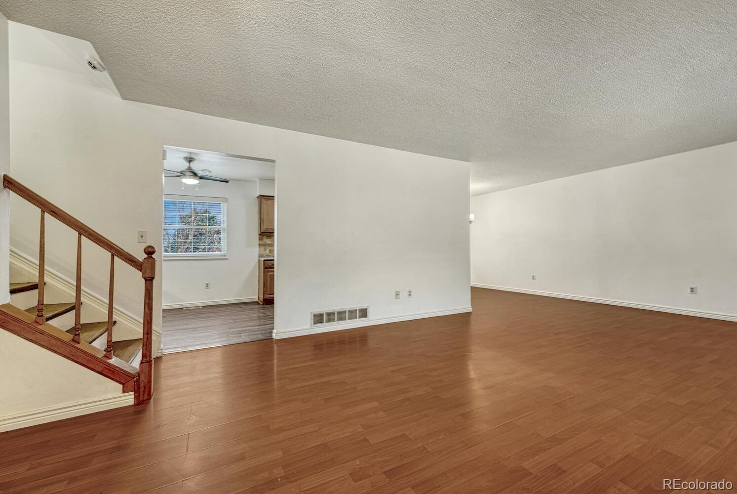 2079 South Quintero Street Aurora, CO 80013 - Photo 6 of 37 a view of an empty room with wooden floor