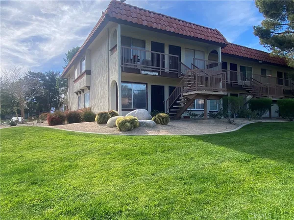 a view of a house with backyard porch and sitting area