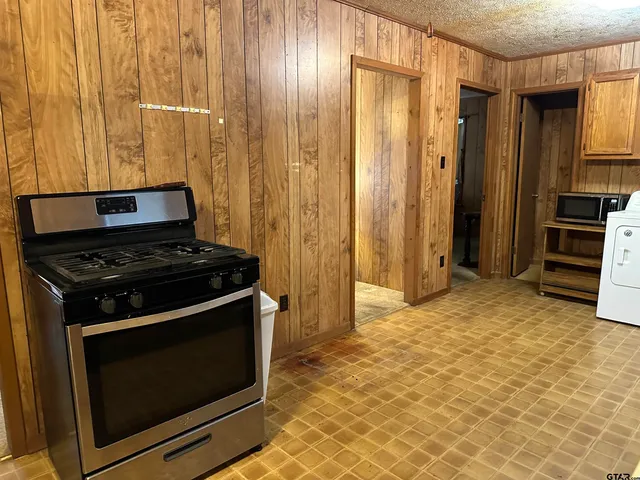 a kitchen with stainless steel appliances a stove and a refrigerator