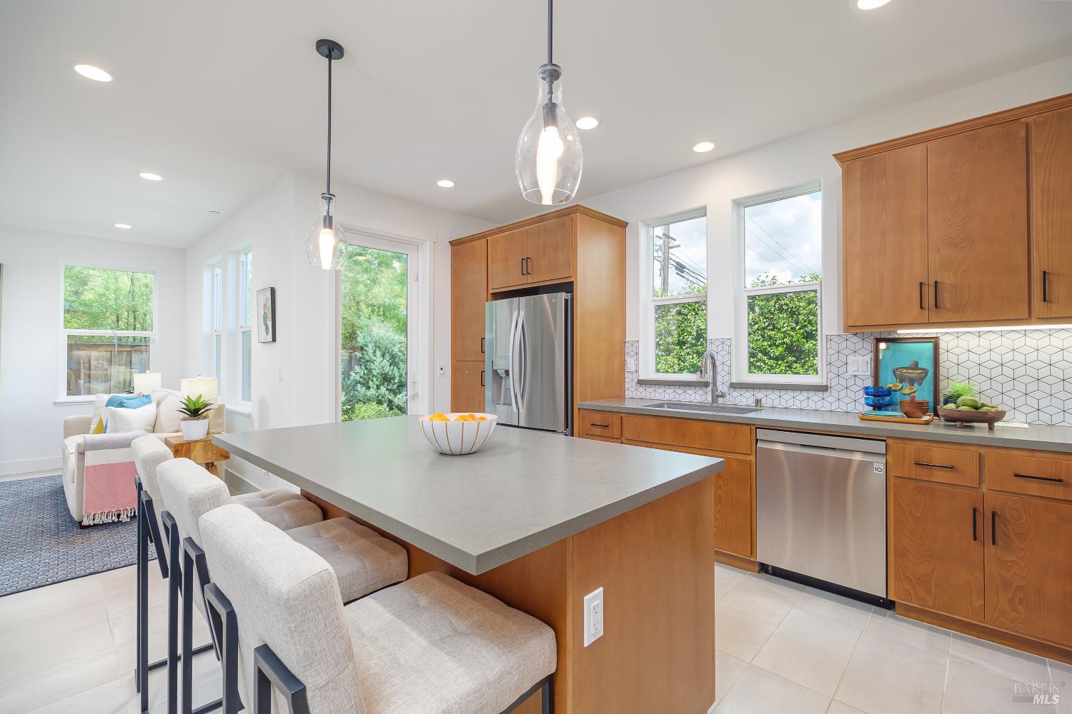 1201 Del Rancho Way Petaluma, CA 94954 - Photo 10 of 56 a kitchen with stainless steel appliances granite countertop a stove top oven a sink dishwasher a dining table and chairs with wooden floor