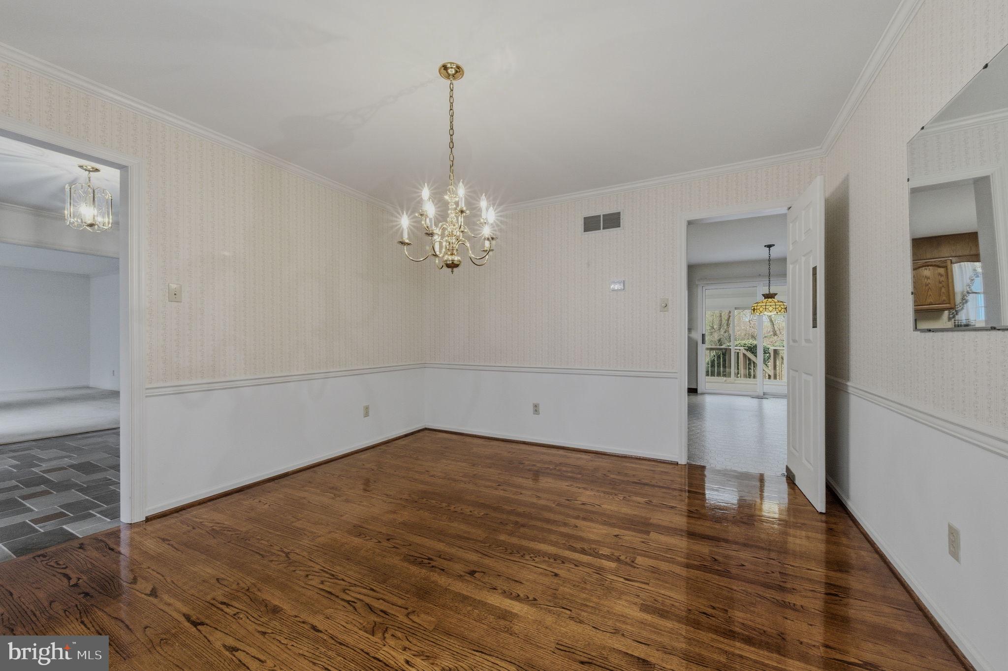 23 Raphael Road Hockessin, DE 19707 - Photo 11 of 44 a view of an empty room with wooden floor and a window