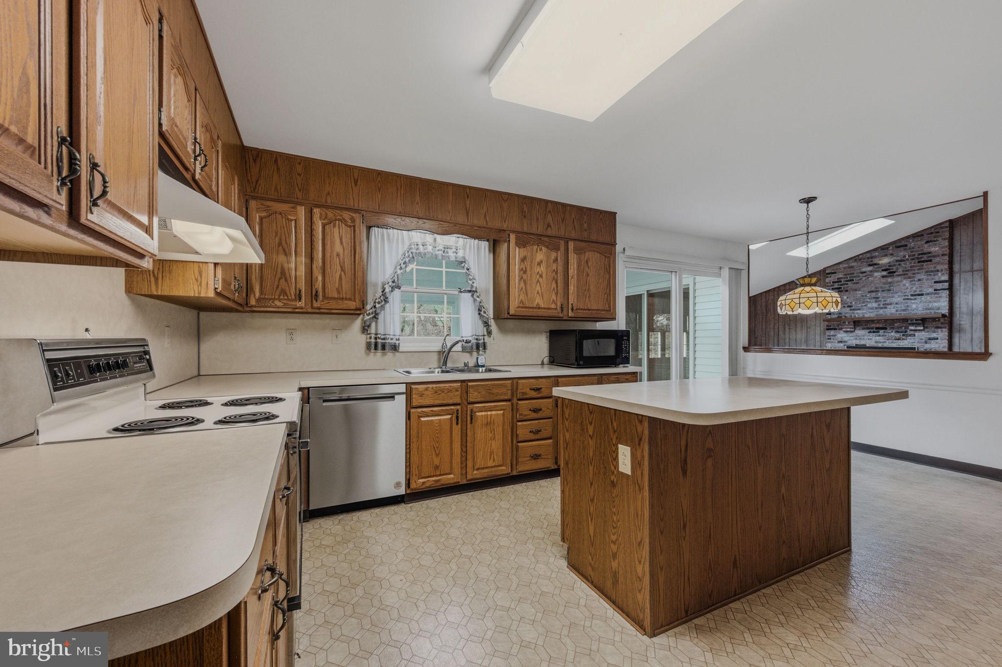 23 Raphael Road Hockessin, DE 19707 - Photo 14 of 44 a kitchen with stainless steel appliances granite countertop a sink stove and refrigerator