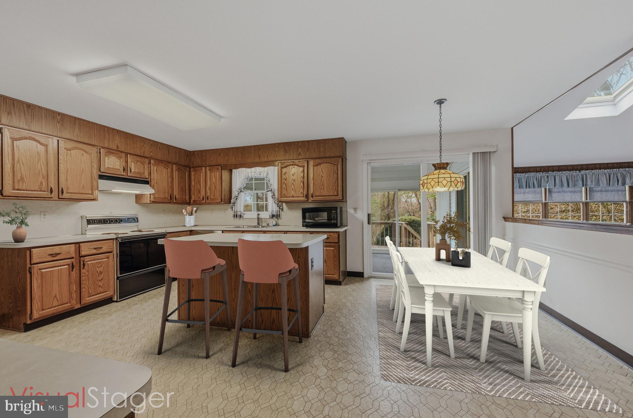23 Raphael Road Hockessin, DE 19707 - Photo 15 of 44 a dining area with stainless steel appliances granite countertop a table chairs and a refrigerator