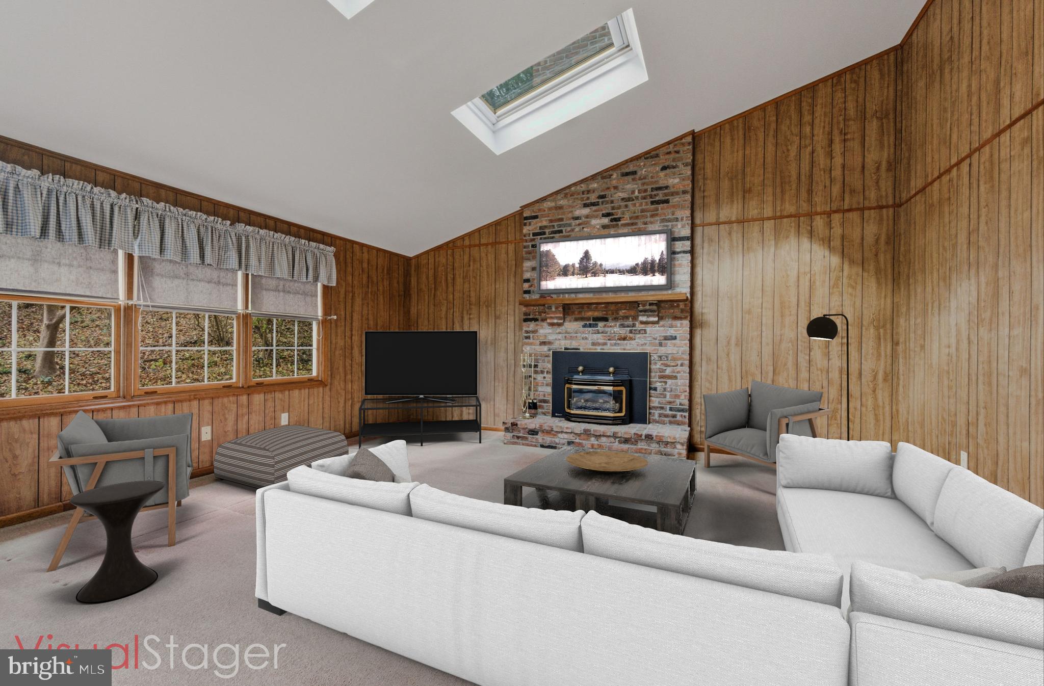 23 Raphael Road Hockessin, DE 19707 - Photo 19 of 44 a living room with furniture a fireplace and a flat screen tv