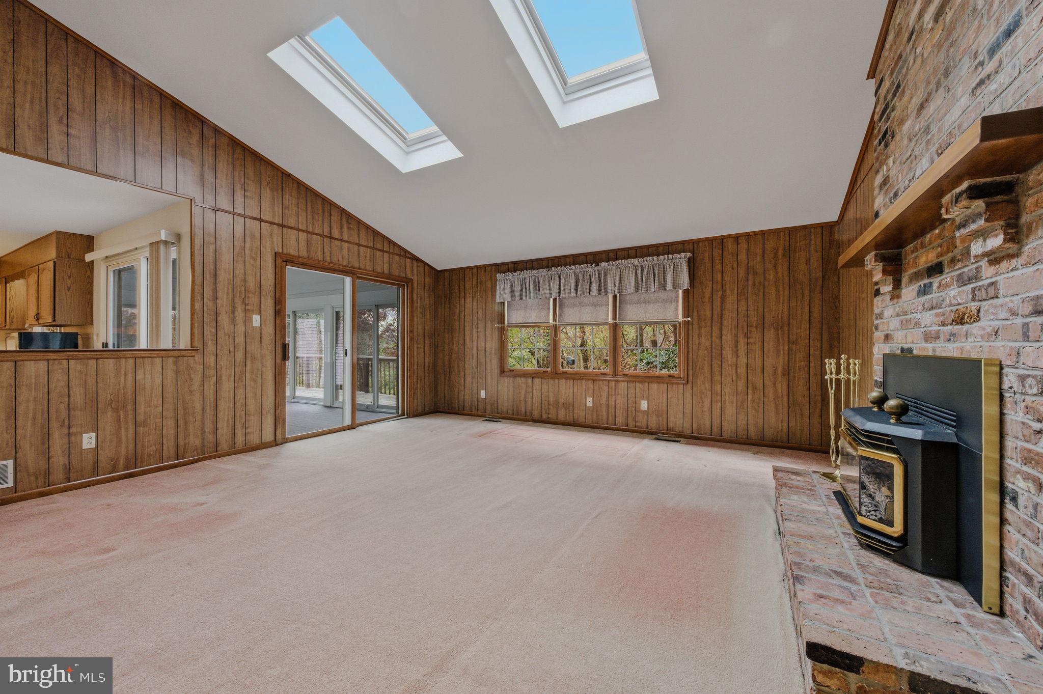 23 Raphael Road Hockessin, DE 19707 - Photo 20 of 44 a view of an empty room with a fireplace and windows