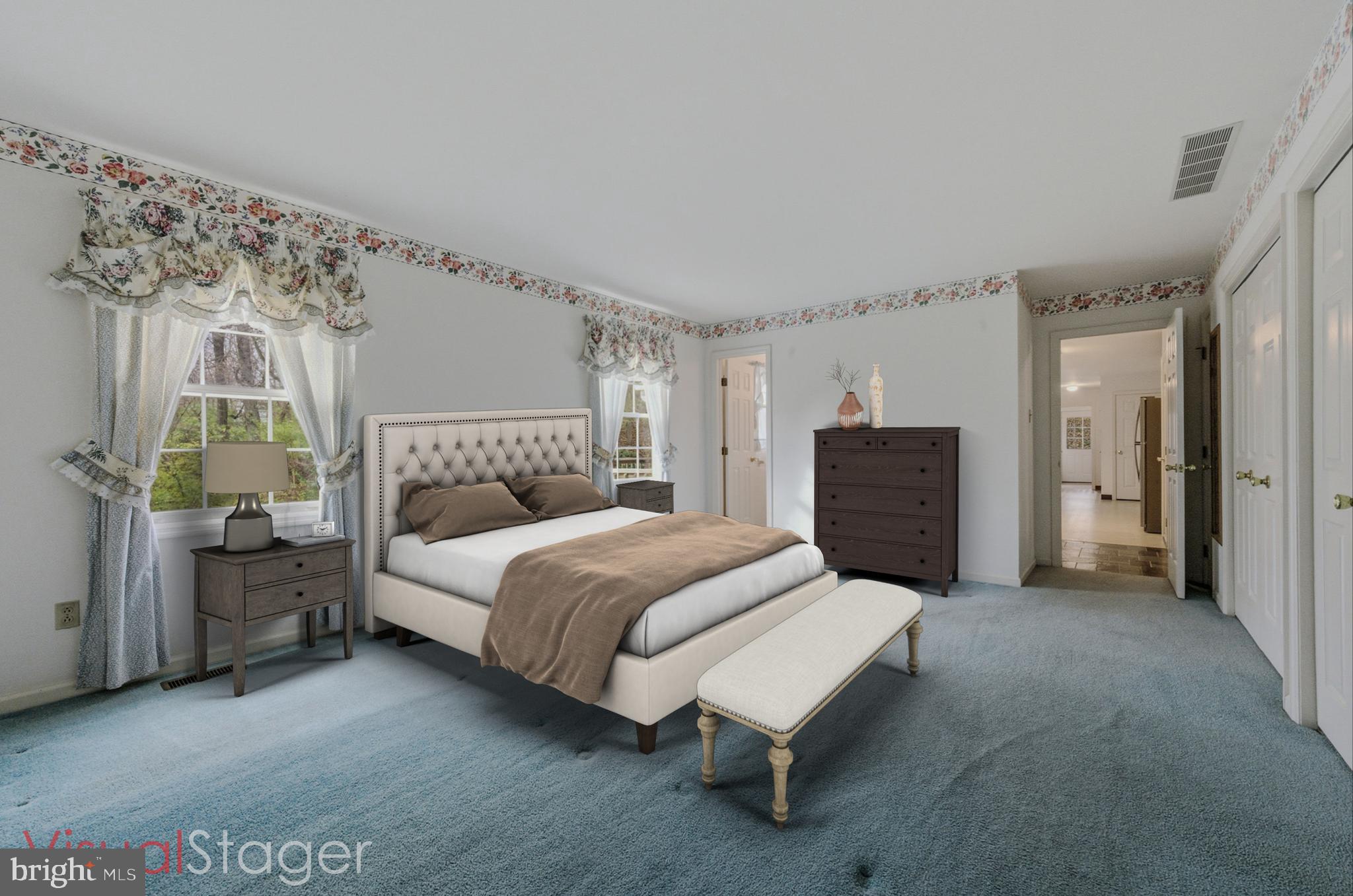 23 Raphael Road Hockessin, DE 19707 - Photo 25 of 44 a spacious bedroom with a bed and a dresser