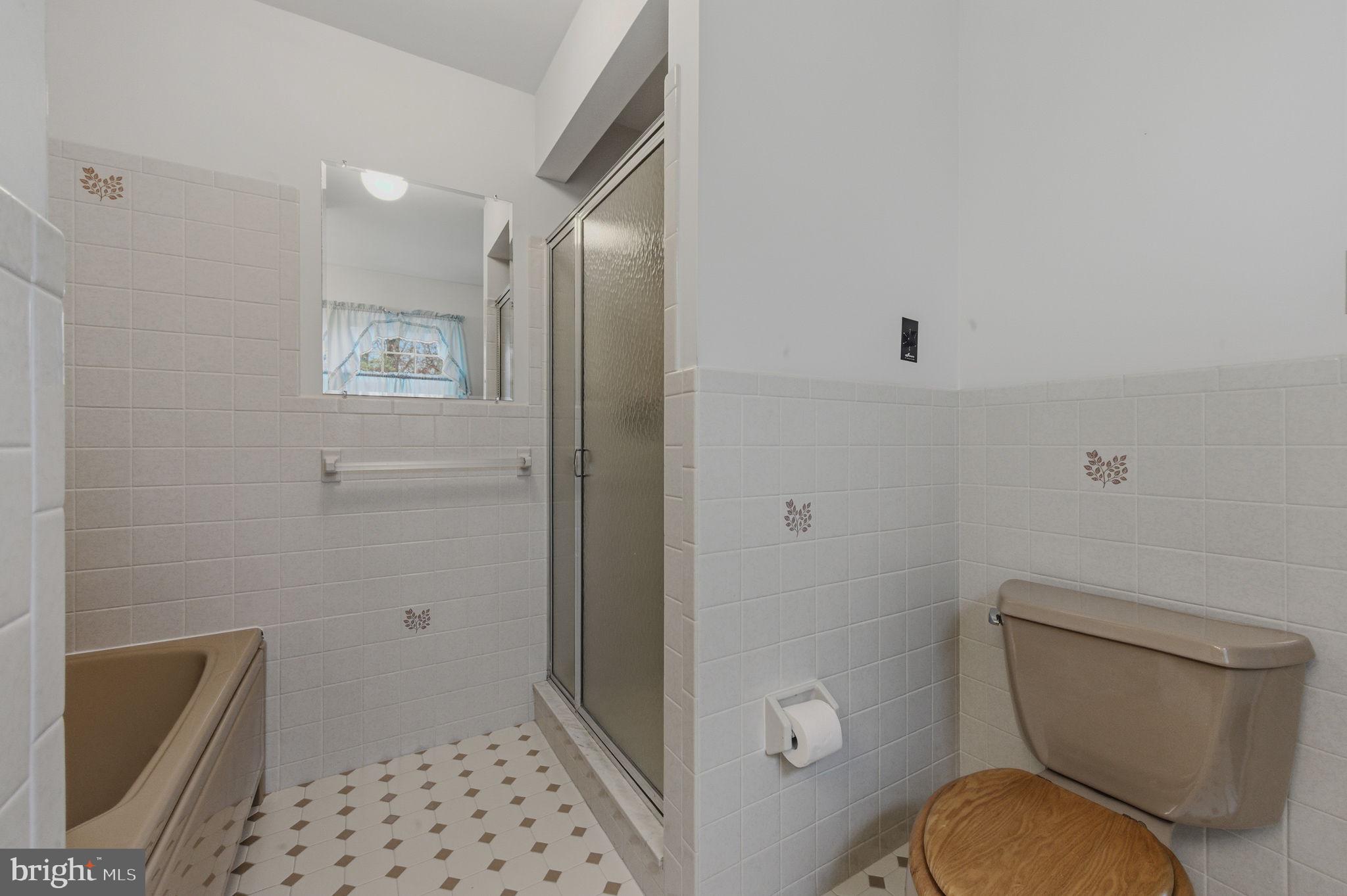 23 Raphael Road Hockessin, DE 19707 - Photo 28 of 44 a bathroom with a toilet and a shower