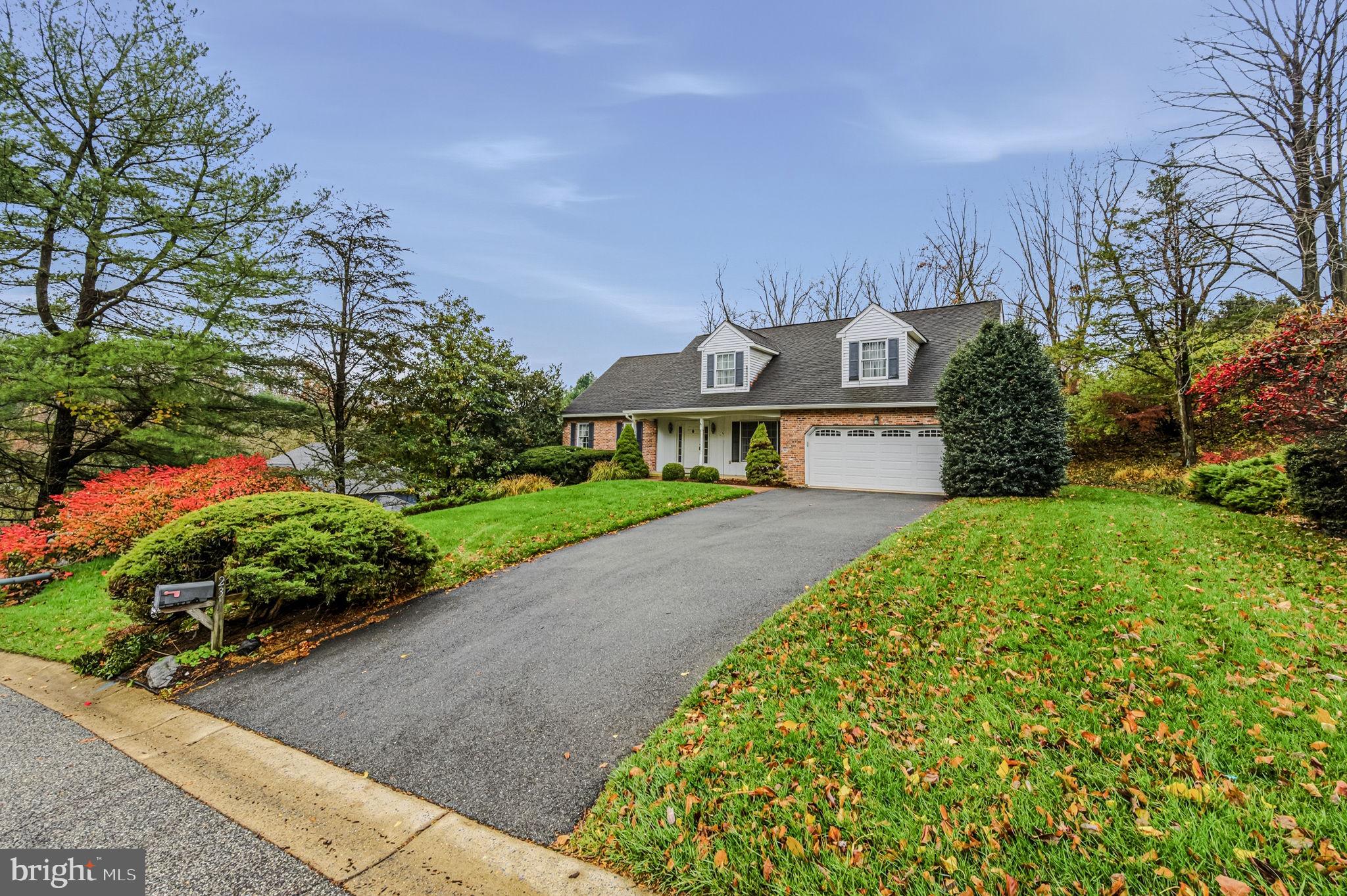 23 Raphael Road Hockessin, DE 19707 - Photo 3 of 44 a front view of a house with a yard and potted plants