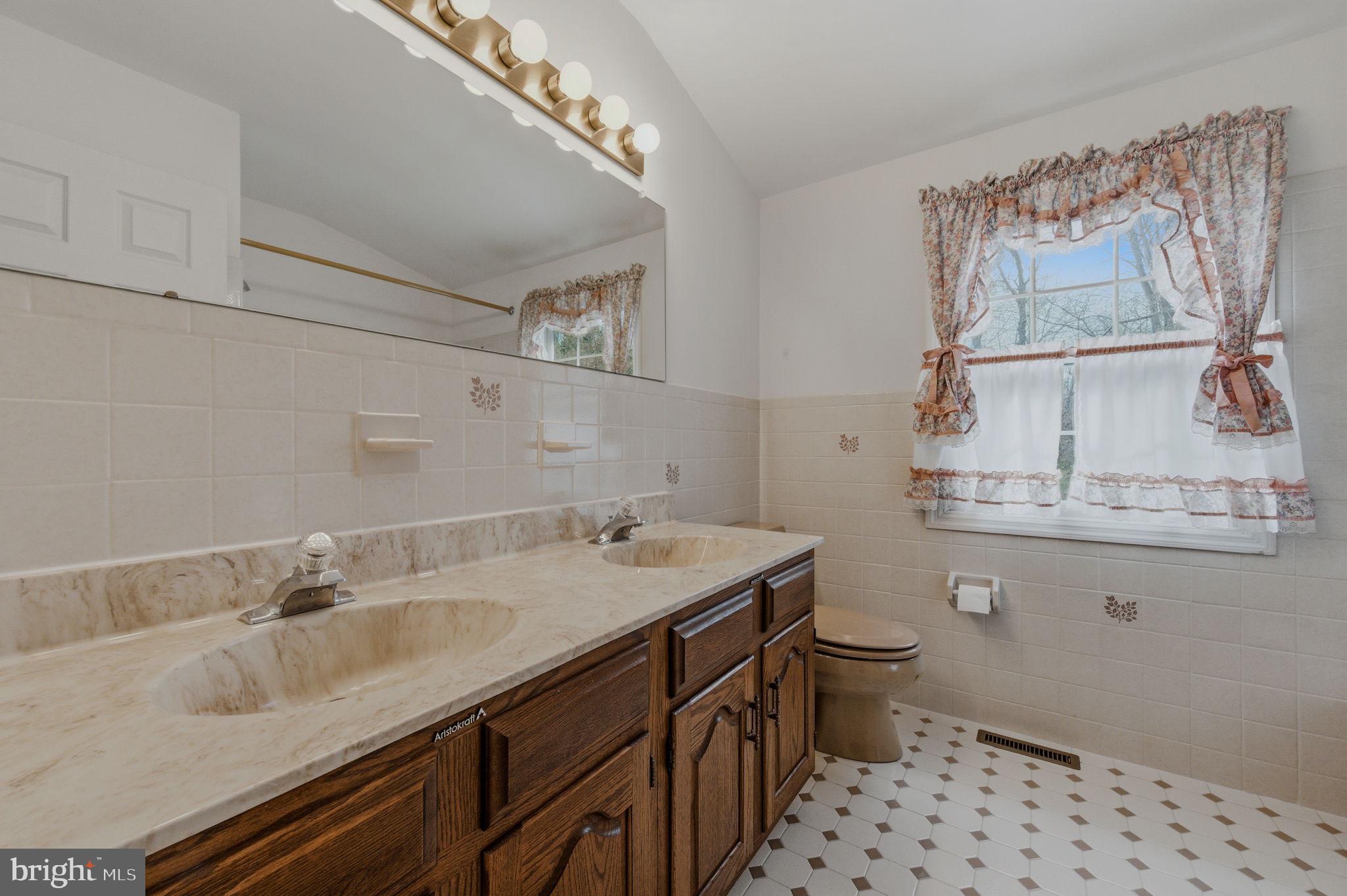 23 Raphael Road Hockessin, DE 19707 - Photo 32 of 44 a bathroom with a sink and a toilet